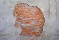 Old and aged wall with flaking plaster and brickwork made of orange brick. Royalty Free Stock Photo