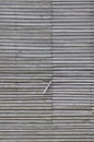 Old weathered natural grey damaged wooden farm shack wall, rustic grungy vertical background closeup, broken boarding pattern Royalty Free Stock Photo