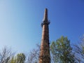 Red brick industrial chimney up in the clear blue sky Royalty Free Stock Photo