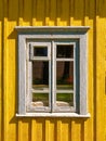 Old aged worn white window closeup exterior view wooden yellow house in the countryside Royalty Free Stock Photo