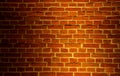 Old aged yellow orange red brick wall in warm artificial light with shadow vignette. A photo good for background or Royalty Free Stock Photo