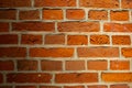 Old aged yellow orange red brick wall in warm artificial light with shadow vignette. A photo good for background or Royalty Free Stock Photo