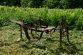 Old agricultural machinery. Old rusty plow on the edge of a agricultural field. Royalty Free Stock Photo