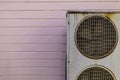 Old Air Conditioner AC Cooling System Unit with Pink Wall
