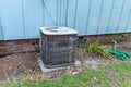 Old Air conditioner system next to home in need of maintenance Royalty Free Stock Photo