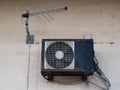 Old air conditioner and tv antenna , rusty outdoor unit