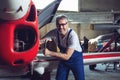 Aircraft maintenance mechanic inspects plane engine Royalty Free Stock Photo