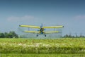 Old airplane flying close to the ground Royalty Free Stock Photo