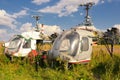 Old airplane fuselage and rusty helicopters on green grass Royalty Free Stock Photo