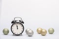 Old alarm clock set to five to twelve on Christmas fir twigs with snow and balls Royalty Free Stock Photo