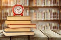 Composite image of old alarm clock and stack of books Royalty Free Stock Photo