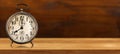 Old Alarm Clock on a Wooden Table and Background - Eight o`clock Royalty Free Stock Photo