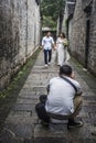 In an old alley in the east gate of Laomen, a photographer taking a wedding photo