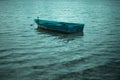 Old alone boat floating in the calm water Royalty Free Stock Photo