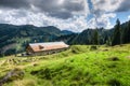 Old alpine hut with meadow in the Alps. Bavaria, Allgau, Germany. Traditional agriculture in the mountains. Royalty Free Stock Photo