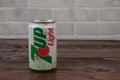 An old aluminium can of 7up soft drink against the brick wall