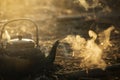 Old aluminum kettle boiling on charcoal or firewood stove Royalty Free Stock Photo