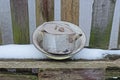 An old aluminum saucepan and an enamelled dirty bowl