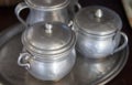 Old aluminum sugar bowls on a tray Royalty Free Stock Photo