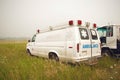 Old american ambulance van Ford Econoline at siberian fields