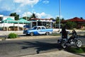Old american cars in cuban streets with the police in the foreground