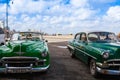 Old american cars on the road in Havana Malecon, Cuba