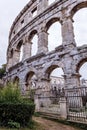 Old amphitheater wall with many arches