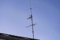 Old analog antenna on a roof with blue sky Royalty Free Stock Photo