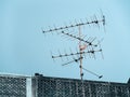 Old analog antenna for TV with blue sky background.