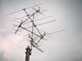 Old analog antenna for TV with blue sky background.