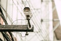 Old analog CCTV outdoor device on wood pole