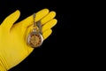 Old analog watch on a latex glove. Hand of a medical worker in a glove with a watch on his hand