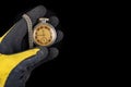 Old analog watch on a work glove. Hand of a production worker in a glove with a watch in his hand Royalty Free Stock Photo