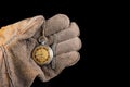 Old analog watch on a work glove. Hand of a production worker in a glove with a watch in his hand Royalty Free Stock Photo