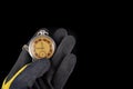 Old analog watch on a work glove. Hand of a production worker in a glove with a watch in his hand Royalty Free Stock Photo