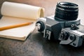 Old analogue camera and notepad Royalty Free Stock Photo