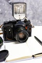 Old analogue camera and notepad. A clean notebook with a fountain pen and a retro camera on the table. Royalty Free Stock Photo