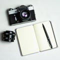 Old analogue camera and notepad. A clean notebook with a fountain pen and a retro camera on the table. Royalty Free Stock Photo