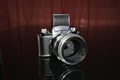 Old analogue manual vintage german SLR camera for 35 mm film on the black background with old german portrait lens Royalty Free Stock Photo