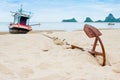 Old Anchor on the beach with ship and sea background as horizont Royalty Free Stock Photo