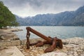 Old anchor on the seacoast on cloudy day. Montenegro, Bay of Kotor Royalty Free Stock Photo