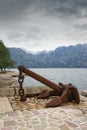 Old anchor on the seashore on a cloudy day. Montenegro, Adriatic Sea, Bay of Kotor Royalty Free Stock Photo