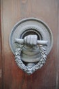 Old ancient door knocker on wooden door Royalty Free Stock Photo