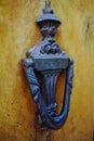 Old ancient door knocker on wooden door Royalty Free Stock Photo