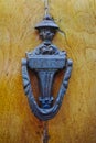 Old ancient door knocker on wooden door Royalty Free Stock Photo