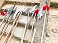 The old ancient medieval cold weapons, axes, halberds, knives, swords with wooden handles lick on the stone steps of the castle Royalty Free Stock Photo