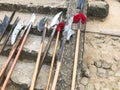 The old ancient medieval cold weapons, axes, halberds, knives, swords with wooden handles lick on the stone steps of the castle Royalty Free Stock Photo