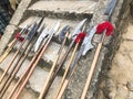 The old ancient medieval cold weapons, axes, halberds, knives, swords with wooden handles lick on the stone steps of the castle