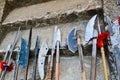 The old ancient medieval cold weapons, axes, olibards, knives, swords with wooden handles lick on the stone steps of the castle