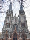 Old ancient medieval gray creepy scary catholic, orthodox Gothic church with spiers. European architecture Royalty Free Stock Photo